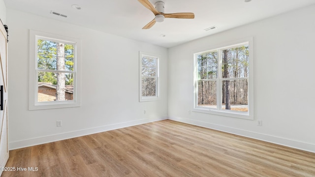 spare room featuring light wood-type flooring and ceiling fan