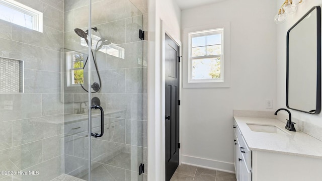 bathroom with vanity, walk in shower, and a wealth of natural light