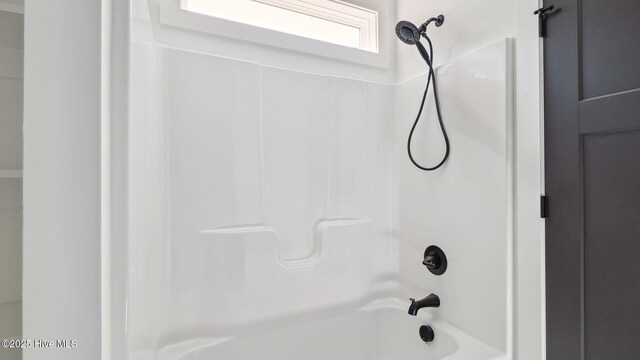 interior details with shower / bath combination