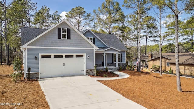 craftsman house featuring covered porch and a garage