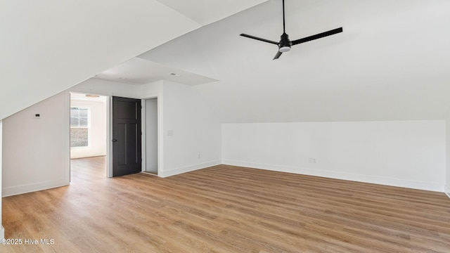 additional living space with light wood-type flooring, vaulted ceiling, and ceiling fan