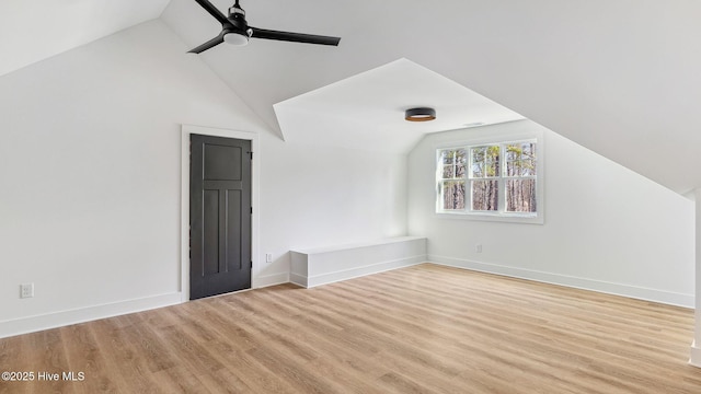 additional living space with light hardwood / wood-style flooring, ceiling fan, and vaulted ceiling