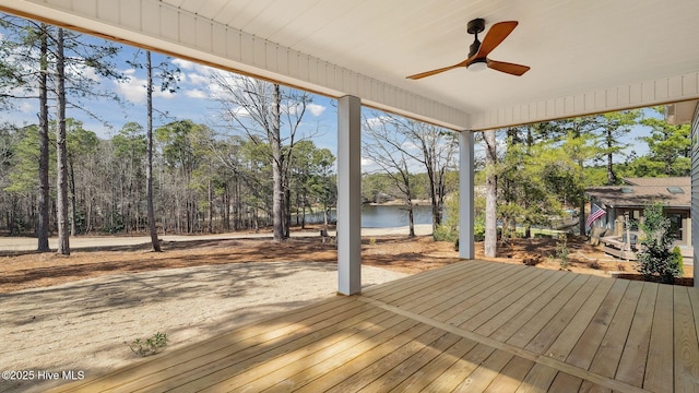 deck with a water view and ceiling fan