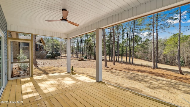 unfurnished sunroom with ceiling fan