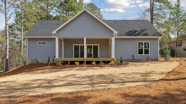 rear view of property featuring ceiling fan