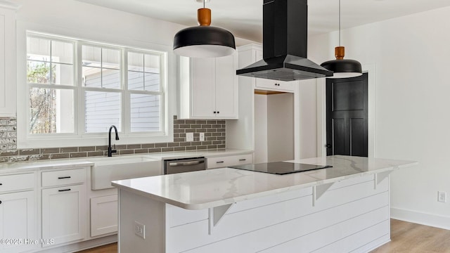 kitchen with island exhaust hood, a center island, white cabinets, hanging light fixtures, and black electric cooktop