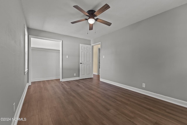 unfurnished bedroom with ceiling fan, a closet, and dark hardwood / wood-style floors