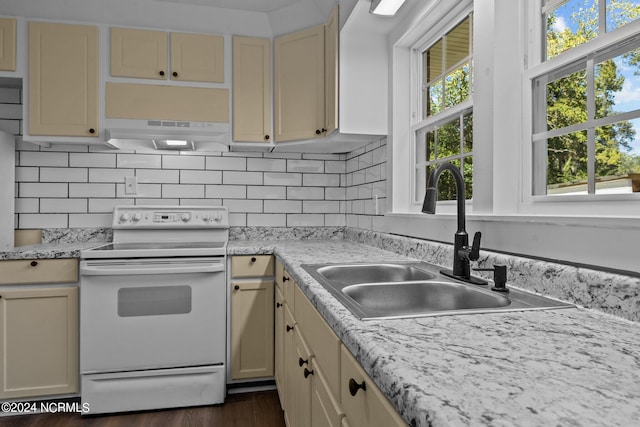 kitchen with cream cabinets, decorative backsplash, dark hardwood / wood-style floors, and electric range