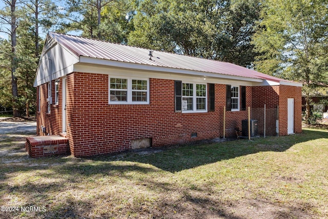 view of property exterior with a lawn