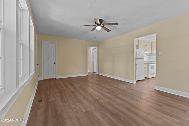 spare room with ceiling fan, a textured ceiling, and light wood-type flooring