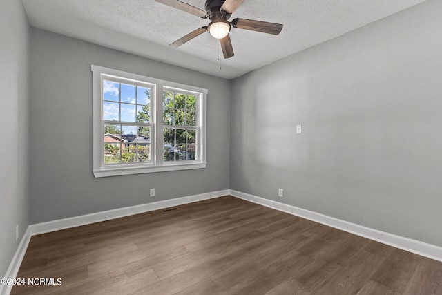 unfurnished room with wood-type flooring, a textured ceiling, and ceiling fan