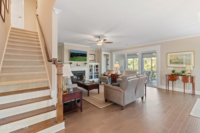 living room featuring ornamental molding, hardwood / wood-style floors, and ceiling fan