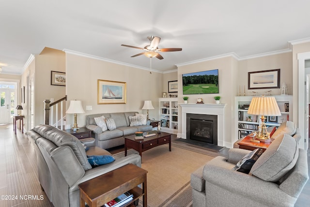 living room featuring hardwood / wood-style flooring, ceiling fan, and ornamental molding