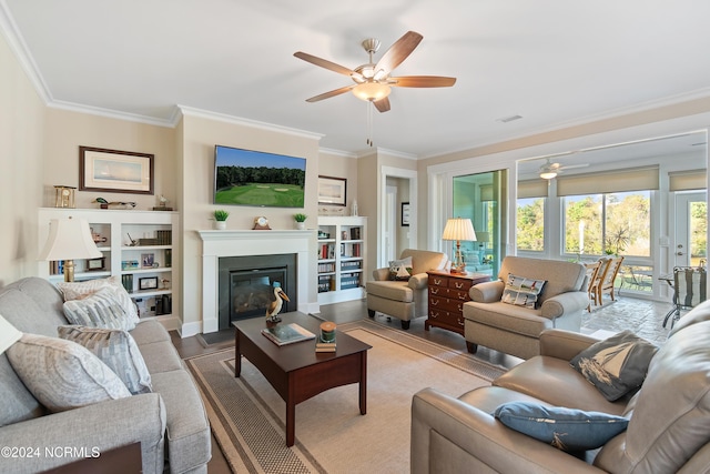 living room featuring wood-type flooring, ceiling fan, and crown molding