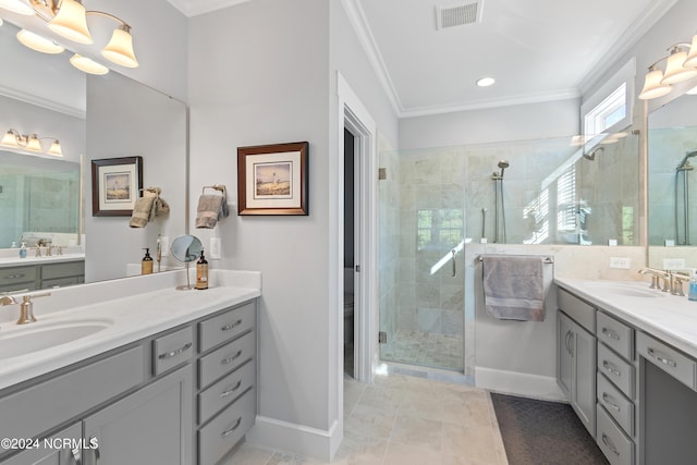 bathroom with crown molding, vanity, tile patterned floors, and a shower with shower door