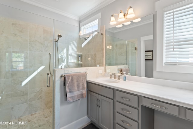 bathroom featuring a shower with door, vanity, and crown molding