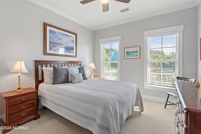 bedroom featuring ornamental molding, multiple windows, and ceiling fan