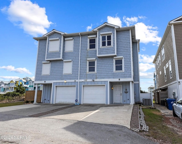 view of property featuring central AC and a garage