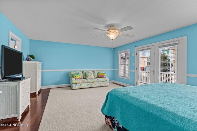 bedroom featuring dark wood-type flooring, ceiling fan, and access to outside