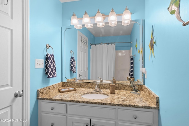 bathroom featuring vanity and a shower with shower curtain