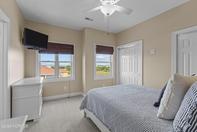 bedroom featuring light colored carpet and ceiling fan