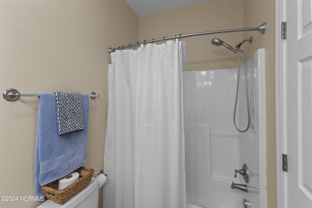 bathroom featuring toilet and shower / bathtub combination with curtain