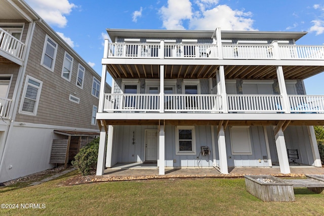 rear view of property with a patio area and a lawn