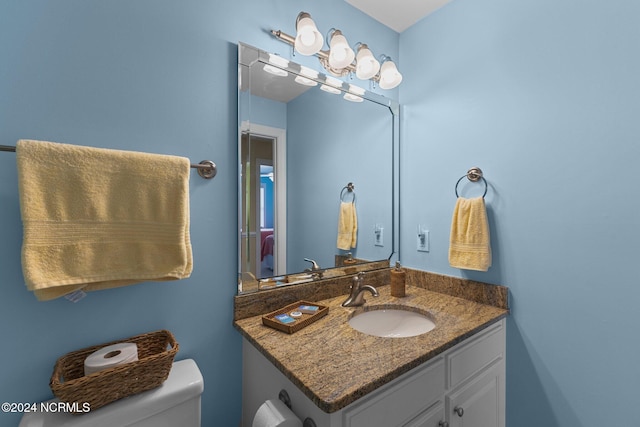 bathroom featuring toilet and vanity