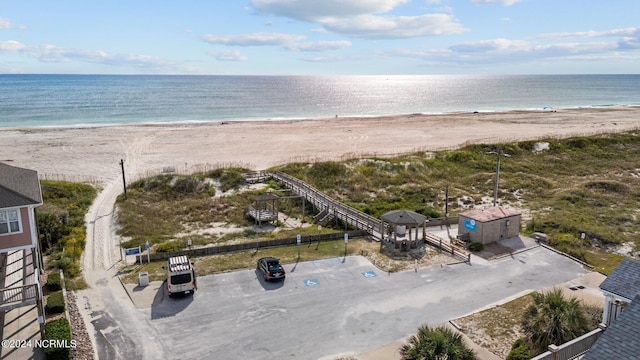 drone / aerial view featuring a water view and a beach view