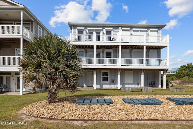 exterior space featuring a yard and a balcony