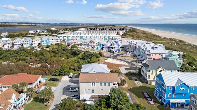 drone / aerial view featuring a water view and a beach view