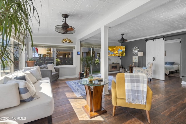 living room with dark wood-type flooring and a barn door