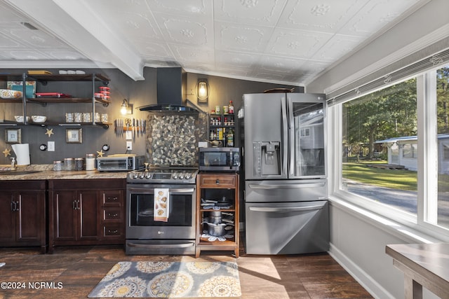 kitchen featuring vaulted ceiling with beams, dark wood-type flooring, stainless steel appliances, dark brown cabinets, and ventilation hood