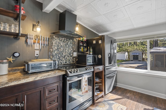 kitchen with dark hardwood / wood-style flooring, extractor fan, dark stone countertops, dark brown cabinetry, and stainless steel appliances