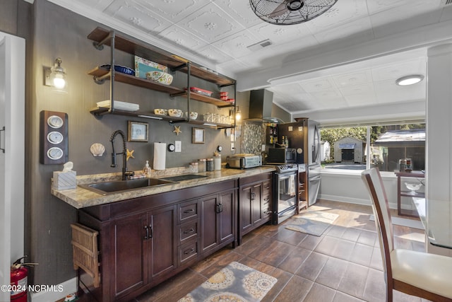 kitchen featuring light stone counters, dark hardwood / wood-style flooring, appliances with stainless steel finishes, range hood, and sink