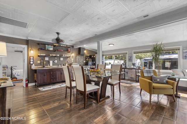 dining area featuring ceiling fan, sink, and dark hardwood / wood-style flooring