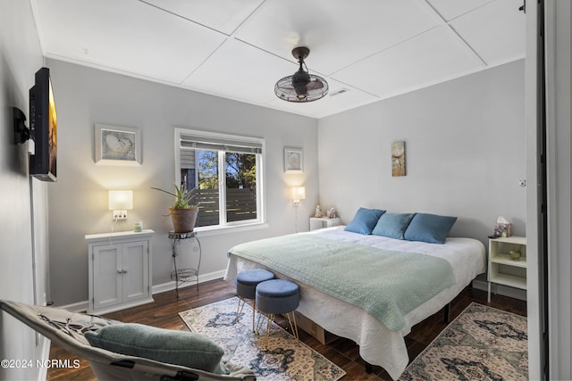 bedroom with dark hardwood / wood-style flooring