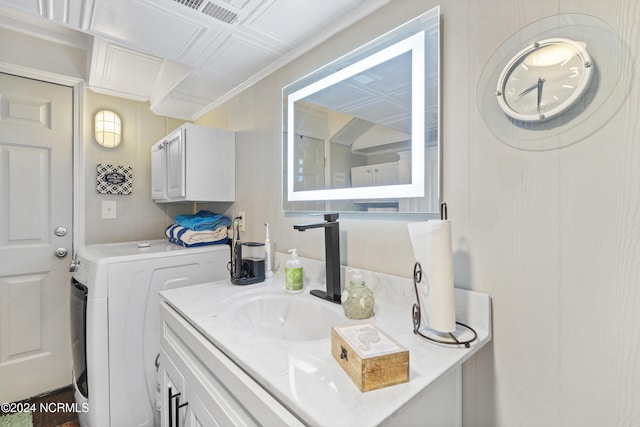 laundry area featuring washer / clothes dryer, sink, and ornamental molding