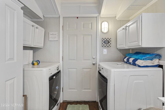 laundry area featuring cabinets, ornamental molding, dark wood-type flooring, and washer and clothes dryer