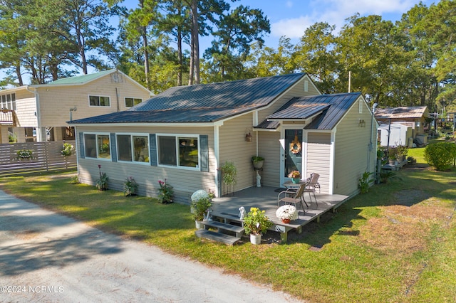 rear view of house with a patio and a lawn