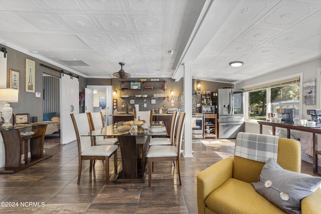 dining space featuring a barn door