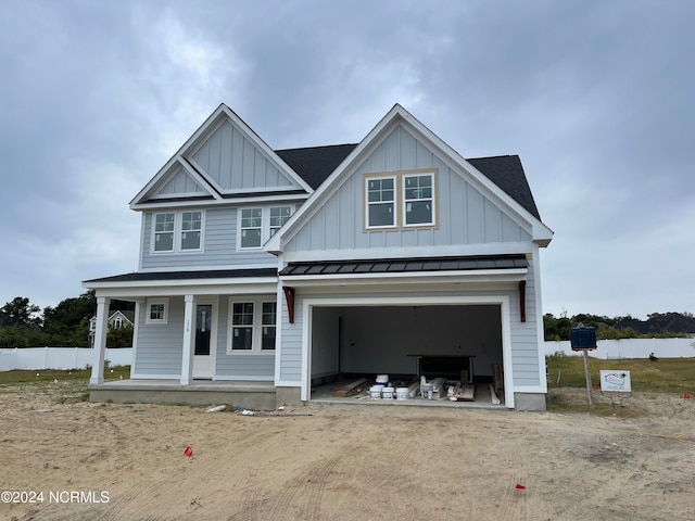 view of front of property featuring a porch and a garage