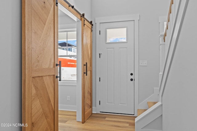 entrance foyer featuring light hardwood / wood-style flooring and a barn door