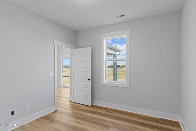 spare room with light hardwood / wood-style flooring