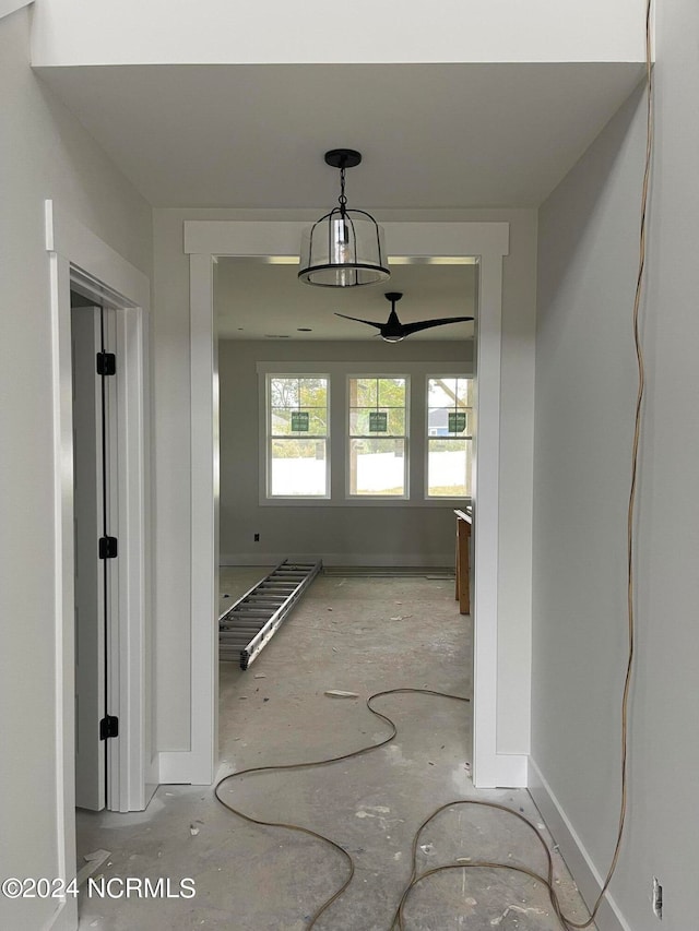 hallway with a notable chandelier