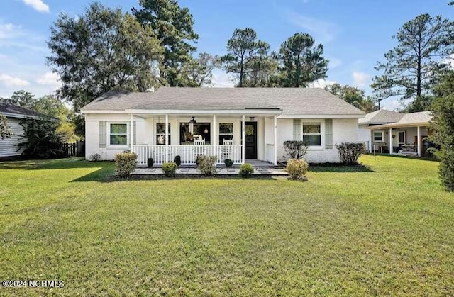 single story home with a porch and a front yard