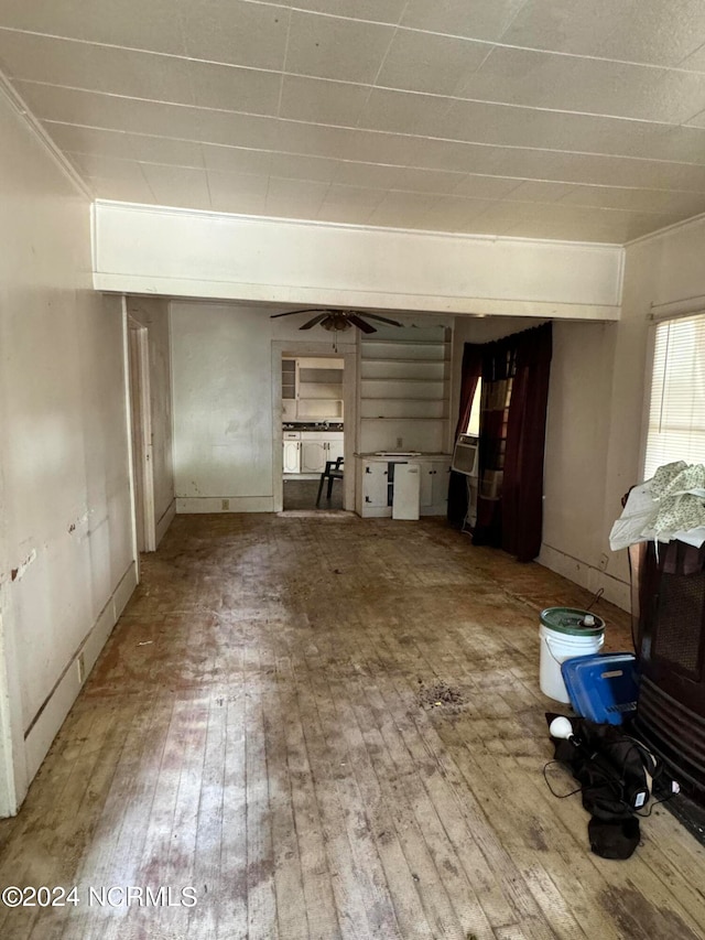 unfurnished living room featuring crown molding, hardwood / wood-style floors, and ceiling fan