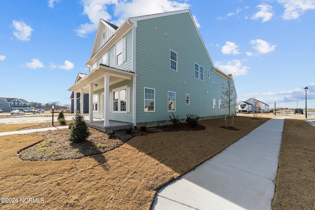 view of property exterior featuring a porch