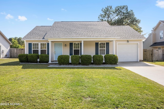 view of front of home featuring a front lawn, covered porch, and a garage