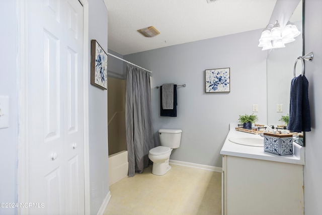 full bathroom with vanity, a textured ceiling, shower / bath combo with shower curtain, and toilet